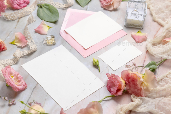Wedding stationery set with envelope laying on a marble table