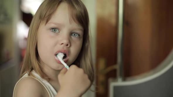 Little Girl Brushing Her Teeth in the Morning or Before Going to Bed