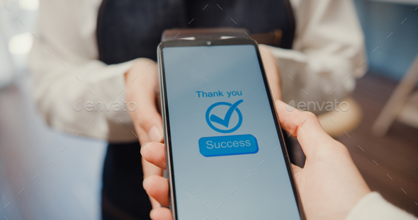 Young Asia female self service use mobile phone pay contactless with credit card reader machine. - Stock Photo - Images