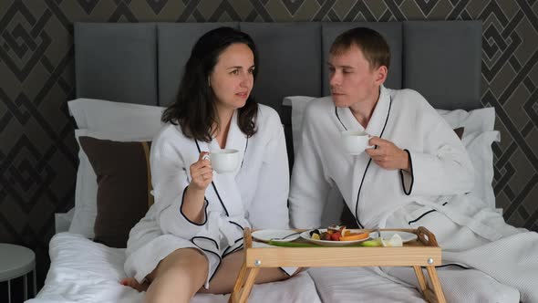Man and Woman Having Breakfast in Hotel Room alt