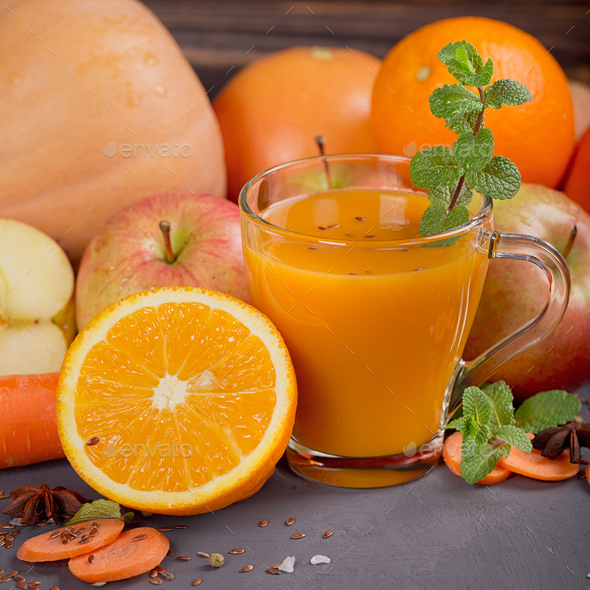 Fresh carrot, apple, pumpkin, orange, grapefruit on dark table. - Stock Photo - Images