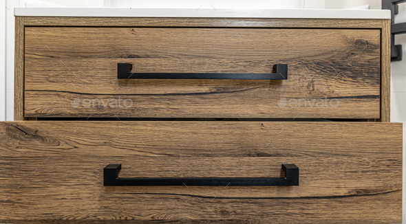 Close-up of modern dark wood furniture with black handles. - Stock Photo - Images
