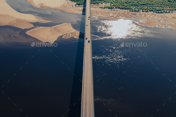 Aerial view of bridge over river in sunset light - Stock Photo - Images