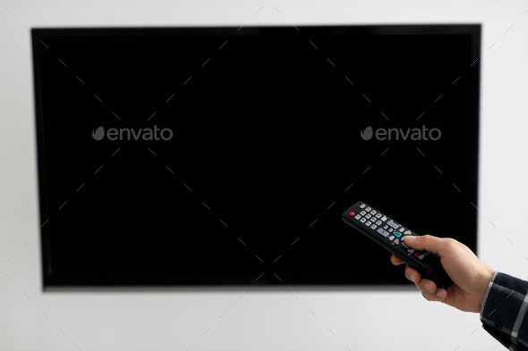 Blank TV Screen And Hand With Television Remote Control Indoor