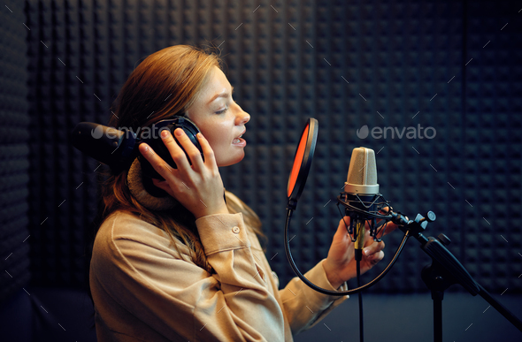 Female singer sings a song, recording studio Stock Photo by NomadSoul1