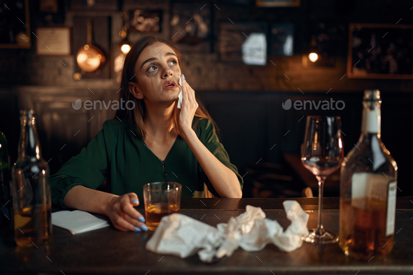 Drunk depressed woman at the counter in bar - Stock Photo - Images