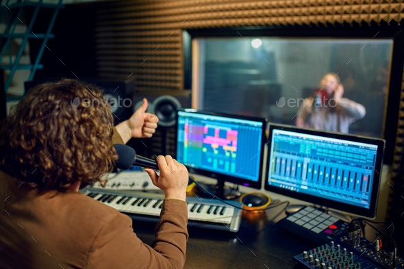 Musician and female performer, recording studio - Stock Photo - Images