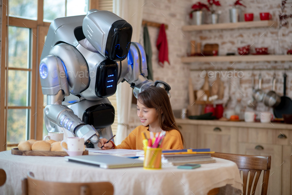 Robot putting his hand on the head of a smiling girl