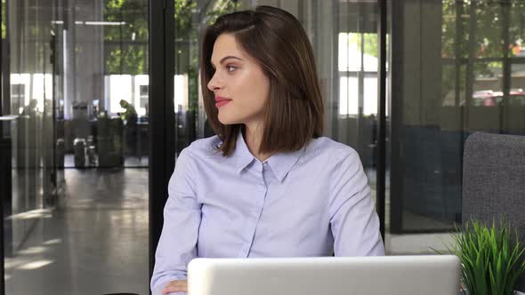 Beautiful Smiling Businesswoman Worker Looking at Camera Sitting at Modern Office alt