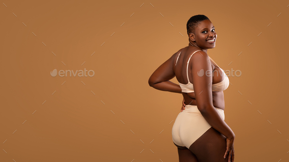 Vertical full length portrait of curvy African American woman