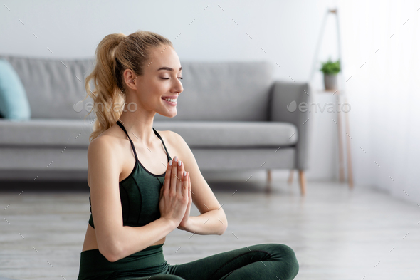 Sport for beginners. Woman practicing yoga lesson, breathing, meditation, exercises