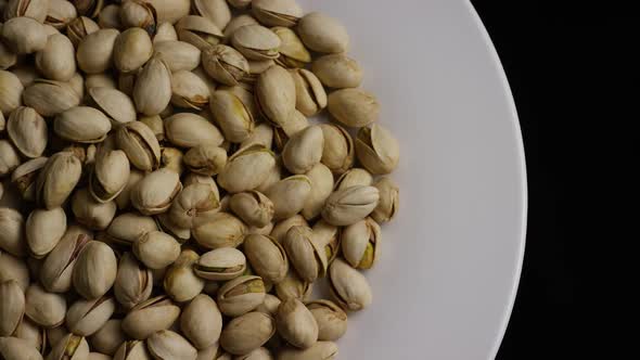 Cinematic, rotating shot of pistachios on a white surface - PISTACHIOS 026 alt