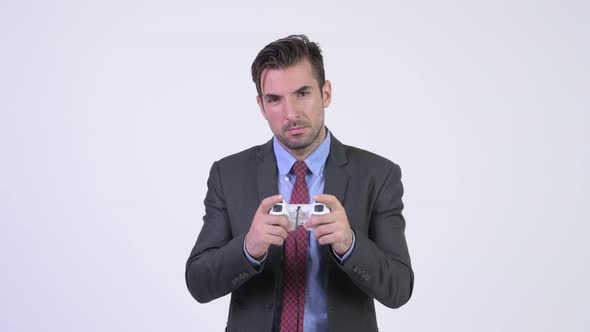 Young Tired Hispanic Businessman Playing Games and Falling Asleep alt