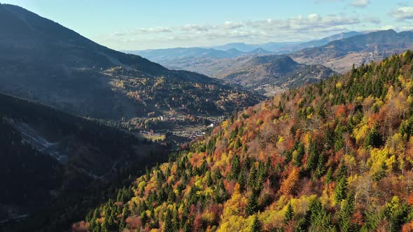 Aerial drone view of nature in Romania. Carpathian mountains, village in a valley alt