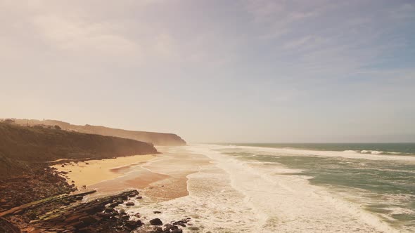Aerial Drone View of Praia Grande Sandy Beach with Cliffs, showing Coastal Scenery and Coastline at alt