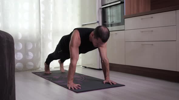Man Does Push-ups From the Floor with the Pull of the Knee To the Elbow