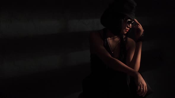 Woman in Hat and Glasses in the Light
