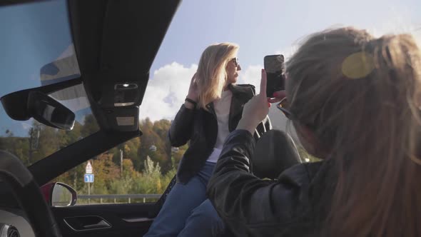 Girls in Cabriolet Makes a Photo By Smartphone in Mountains