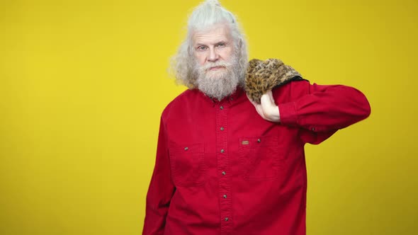 Confident Rich Senior Man Putting Luxurious Fur Coat on Shoulder and Smiling at Camera alt