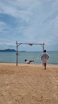 Men and Women Relaxing in Hammock on the Beach in Pattaya Thailand Ban Amphur Beach alt