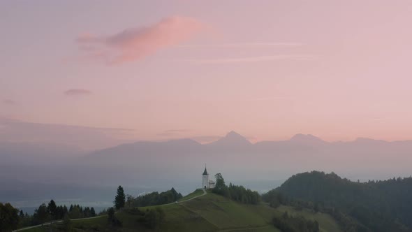 Sunrise over small church in Slovenia