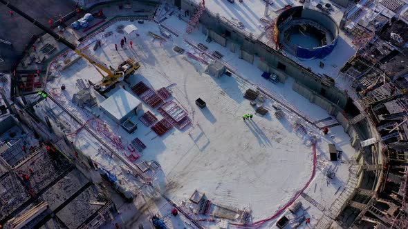 Snowy Ground with Working Builders and Machines at Sunrise alt