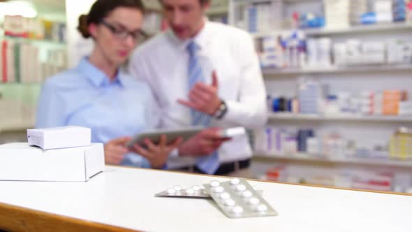 Various boxes and bottles of medicine on table alt