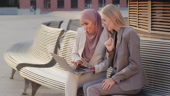 Smiling Business Women Sitting Outdoors with Laptop Looking at Screen Satisfied Result Showing Like alt