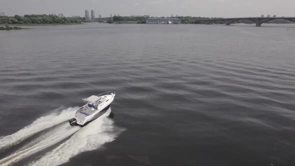 Aerial View of Luxury White Speed Boat Cruising in High Speed in Blue Sea