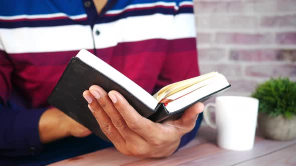 Man's Hand Turning a Pager of a Diary