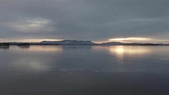 Spectacular aerial view of ice forming on Moosehead lake at golden hour alt
