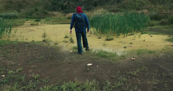 Hiker with a Backpack Approached the Swamp