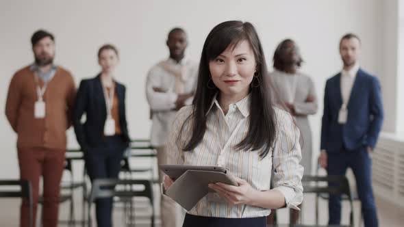 Asian Businesswoman Posing with Tablet Computer alt