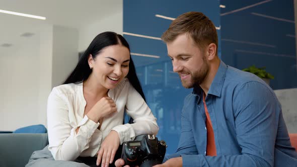 Photographer and Model Watch Photos Sitting in the Business Center alt