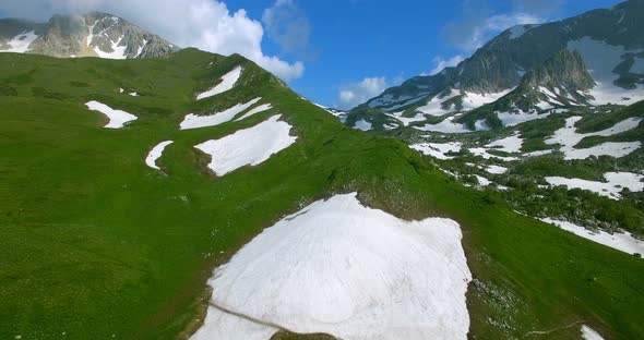 Aerial View Mountain Pass With Glaciers And Green Grass In Mountains Of Caucasus alt