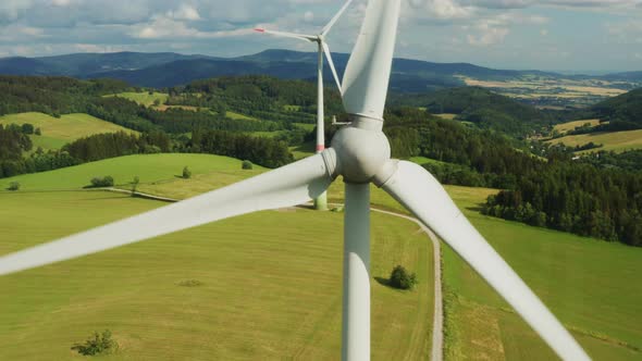 Close Up a Propeller of the Windmill in the Yellow Field with Mountains on the Background alt