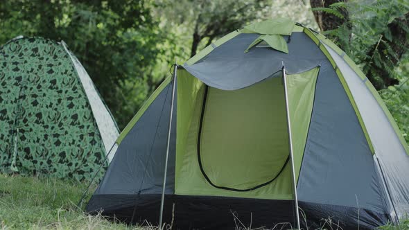 Family mom and son playing together near tent. Happy childhood and motherhood. alt
