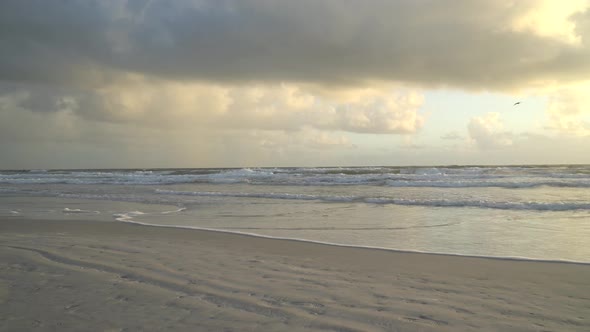 Waves splashing on the beach at high tide during sunrise at the Atlantic Ocean Central Florida alt
