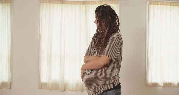 Pregnant woman holding her belly alt