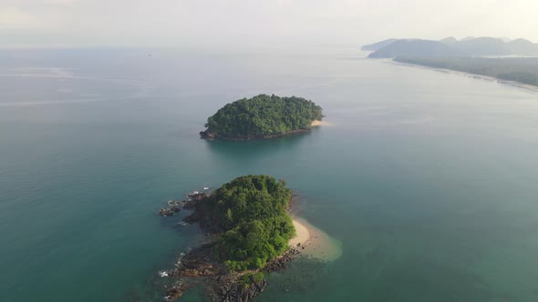 Aerial view and fly over small island in ocean with bright light in the morning of Andaman Thailand