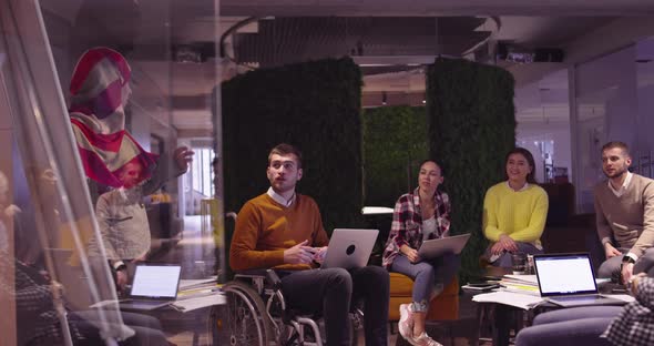 Muslim Woman in a Modern Open Space Coworking Office Giving a Presentation to Team alt