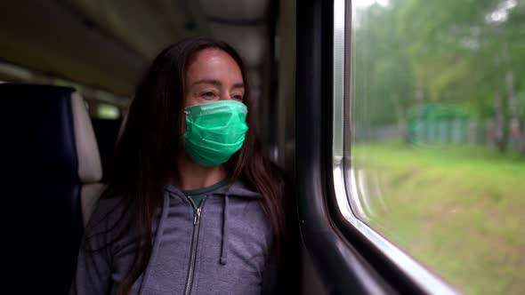 A Close-up Portrait of a Dark-haired, Middle-aged Woman Wearing a Medical Mask. She Is Riding the alt