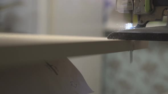 Master of Furniture Production Saws the Surface of the Table with an Electric Jigsaw 3 alt