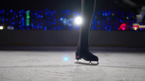 Dancing on Ice Professional Man Gymnast Performs a Trick on Ice Man Spinning on Skates a View of the alt