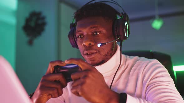 Portrait Shot of Focused Young Black Man Professional Game Player Playing Video Games alt