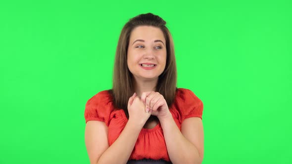 Portrait of Cute Girl Is Waiting in Anticipation with Pleasure. Green Screen alt
