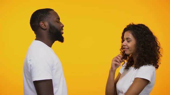 Playful Afro-American Man Flirting With Cute Woman, Inviting for Romantic Date alt