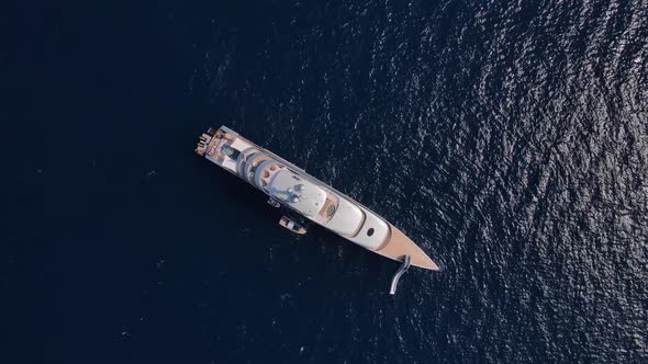 Private luxury yacht and small jet boat at the anchorage, top aerial view. Private huge super yacht.