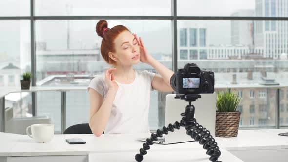 Beautiful Girl Recording Video on Camera at Office. Fashion Blogger Concept