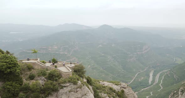 People Resting In Montserrat Mountains Is A Rocky Range Located Near The City Of Barcelona In alt